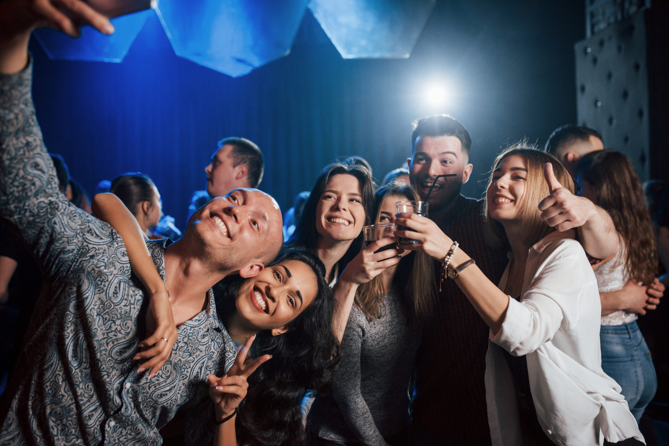 amazing party. friends taking selfie in beautiful nightclub. with drinks in the hands